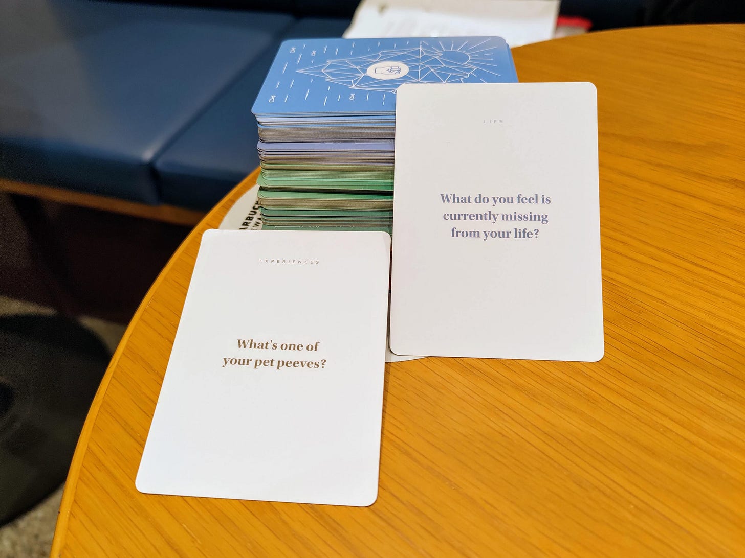 Physical question cards with prompts laid out on a table.